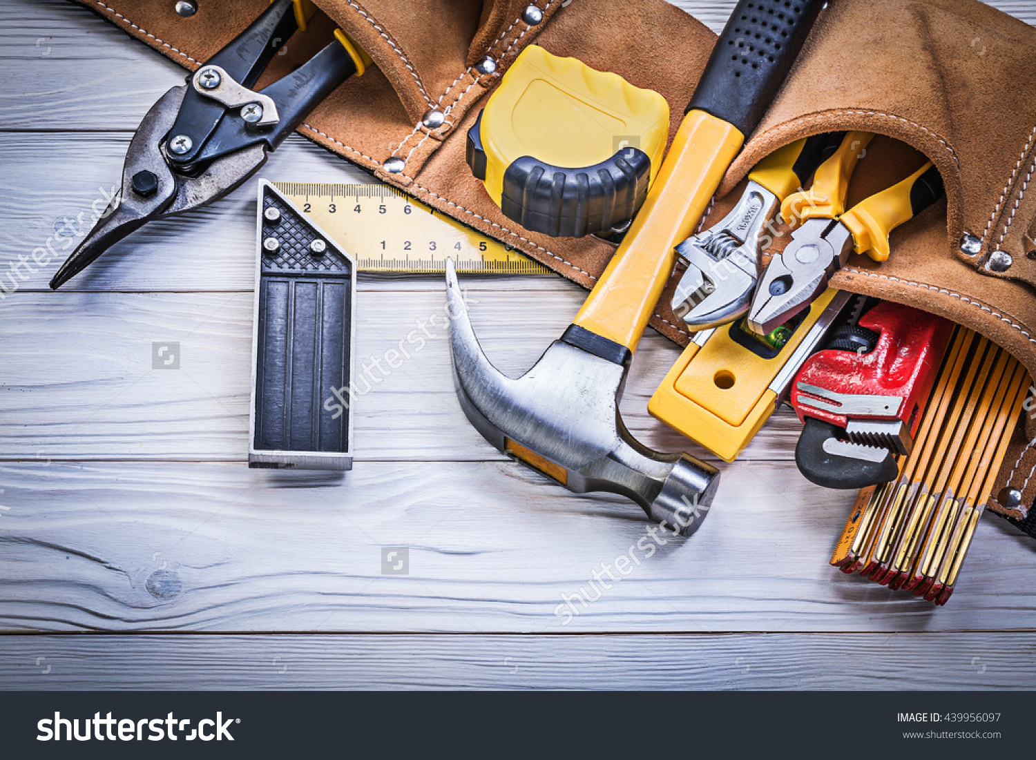 stock-photo-leather-tool-belt-with-construction-tooling-on-wooden-board ...